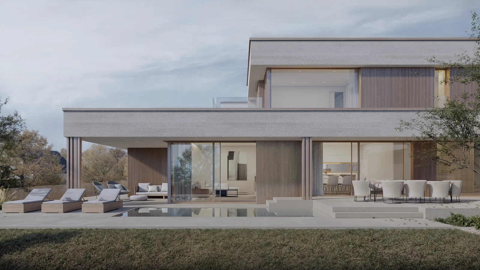Haus WR: Gartenseite mit Pool am Abend